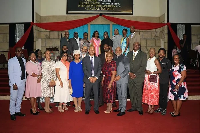 In the group photo, front row: MInister of Social Services, Information and Broadcasting the Hon. Myles LaRoda (centre); Apostle Raymond Wells (fifth right) and Pastor Olivia Wells (sixth right); Director General of Bahamas Information Services Elcott Coleby (fourth right); BIS Assistant Director/Editorial Camilla Cheong (fifth left); BIS Human Resources Manager Kathryn Campbell (third left); Chair of the Golden Jubilee Planning Committee Lindsay Thompson (third right); Committee Deputy Chair Cassandra McKenzie (second left); and BIS staff and planning committee members. (BIS Photos)