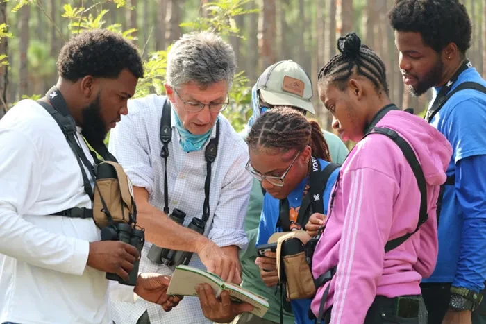 BAMSI students and TCI birdwatchers debate the identification of a bird