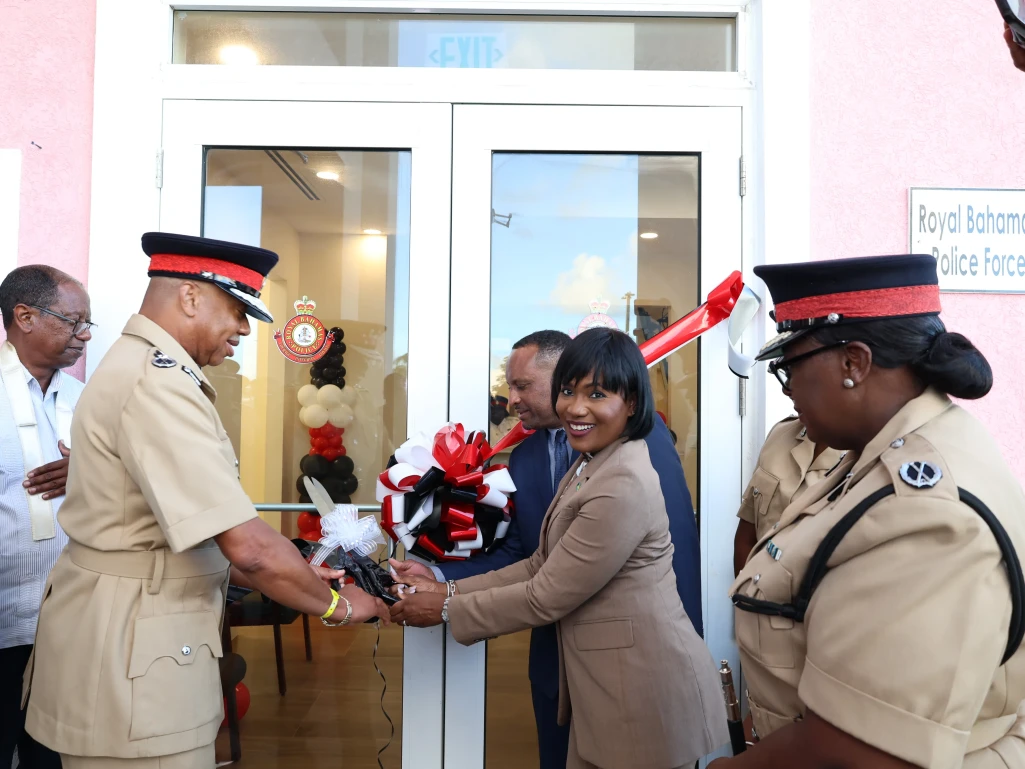 CUTS RIBBON – Minister for Grand Bahama, the Hon. Ginger Moxey, along with police Commissioner Clayton Fernander (left) and MP Kingsley Smith prepare to cut the ribbon on the entrance of the new Eight Mile Rock Police Station located in the Obadiah Wilchcombe Complex, following official opening ceremonies on Tuesday, November 12, 2024.  Looking on at right is Assistant Commissioner of Police, Ms. Shanta Knowles.  (BIS  Photos/Andrew Miller)