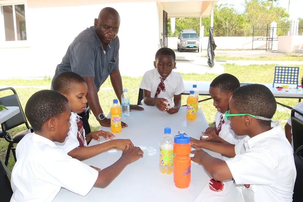 Boys enjoy playing board games, celebrating International Day of the Boy Child