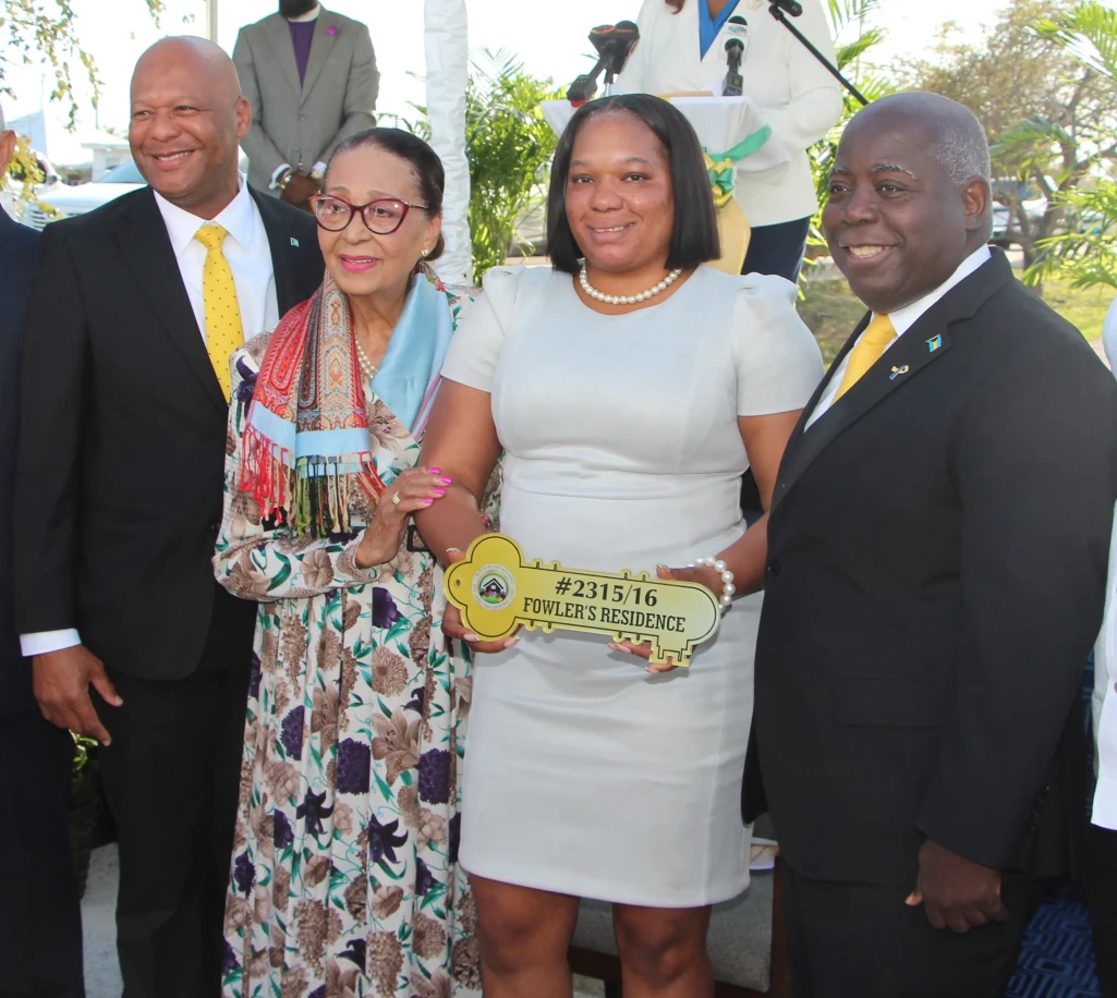 L-r Housing and Urban Renewal Minister Keith Bell, Dame Marguerite Pindling, New Home Recipient, and Prime Minister Philip Davis