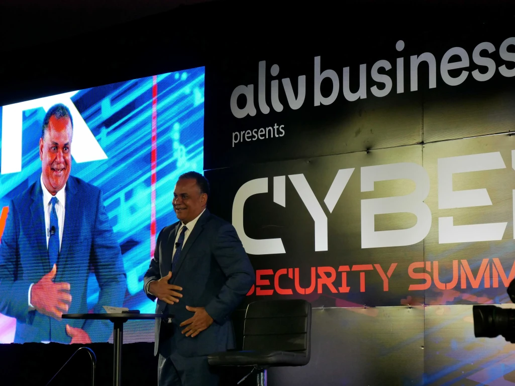 Minister of Economic Affairs, Senator the Hon. Michael Halkitis delivering welcome remarks at the ALIV Business Cyber Security Summit 2025.