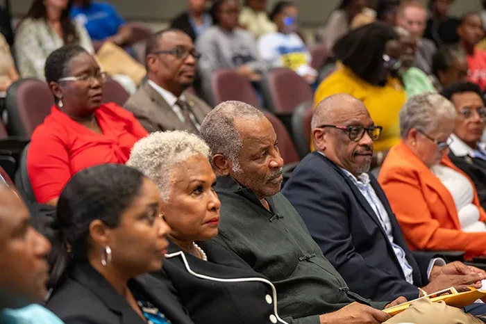 Sir Franklyn Wilson and Sharon Lady Wilson; Minister of Education and  Technical & Vocational Training, the Hon. Glenys Hanna Martin; former Prime Minister, the  Most Honourable, Dr. Hubert Minnis; and other esteemed members of the audience observe the  research presentations.