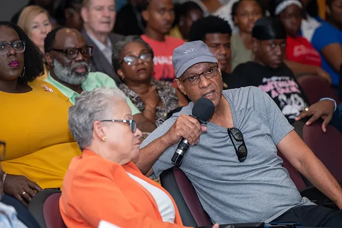 Former Chair of UB's Board of Trustees, Dr. K. Jonathan Rodgers,  participates in the question and answer period following the research presentations.
