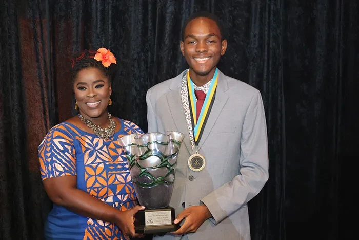 <strong>Aidan Hanna</strong> receives the 2024 Director’s Cup from Minister of State in the  Ministry of Environment and Natural Resources and Governor-General representative the Hon. Zane Lightbourne; at the recent Nominee Medal Presentation and National Youth Awards Ceremony, held at Envgelistic Temple, on October 29, 2024. <br/> (BIS Photo/Eric Rose)
