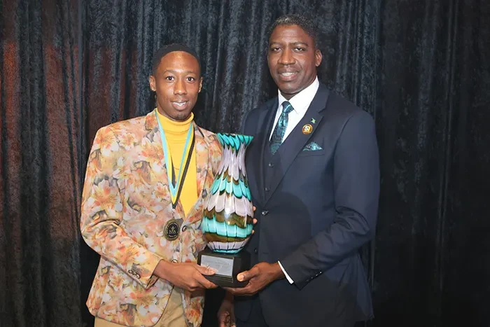 <strong>Navado Dawkins </strong> receives the 2024 Minister’s Cup from Minister of State in the Ministry of Environment and Natural Resources and Governor-General representative the Hon. Zane Lightbourne; at the recent Nominee Medal Presentation and National Youth Awards Ceremony, held at Envgelistic Temple, on October 29, 2024. <br/>(BIS Photo/Eric Rose)