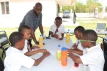 Boys enjoy playing board games, celebrating International Day of the Boy Child